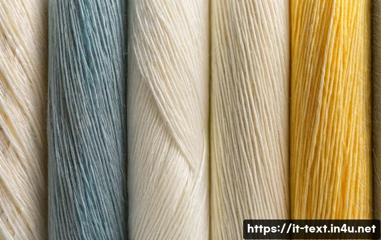 섬유기사와 필기시험 준비 단계 - A detailed close-up image of various textile fibers arranged side by side on a neutral background, s...